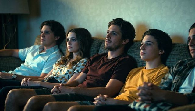 Watching together on couch at night responding to screen light family bonding moment