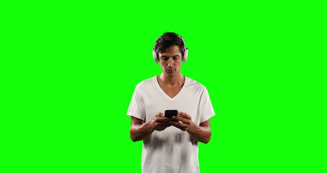 Man Wearing Headphones Using Smartphone Isolated on Green Screen - Download Free Stock Images Pikwizard.com