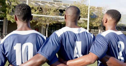 Team unity among soccer players standing together outdoors