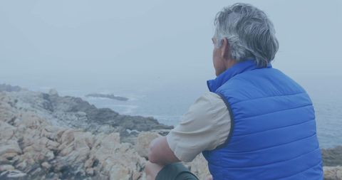 Man Contemplating Sea from Rocky Shore - Download Free Stock Images Pikwizard.com