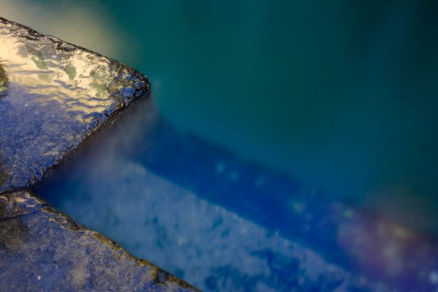Serene Stone Edge Pool with Clear Blue Water - Download Free Stock Photos Pikwizard.com