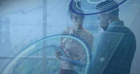 Business collaborators reviewing tablet with futuristic hud overlay, analyzing data and planning