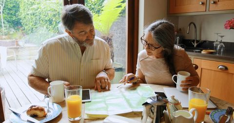 Senior Couple Planning Trip Over Breakfast Conversation - Download Free Stock Images Pikwizard.com