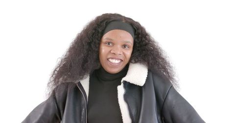 Smiling woman in stylish jacket exuding confidence