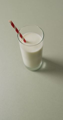 Refreshing Glass of Milk with Striped Straw on Grey Background - Download Free Stock Images Pikwizard.com