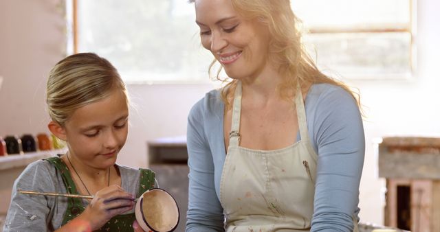 Woman Teaching Young Girl Pottery Painting in Sunlit Studio - Download Free Stock Images Pikwizard.com