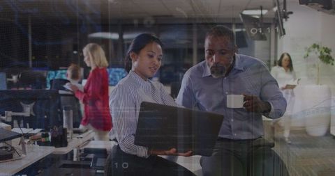 Diverse professionals collaborating in modern office on technology projects
