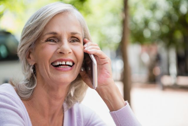 Senior Woman Smiling While Talking on Mobile Phone Outdoors - Download Free Stock Photos Pikwizard.com