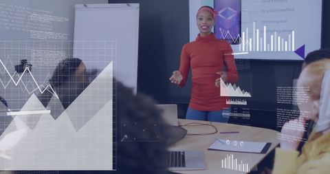 Businesswoman analyzing data charts during team meeting