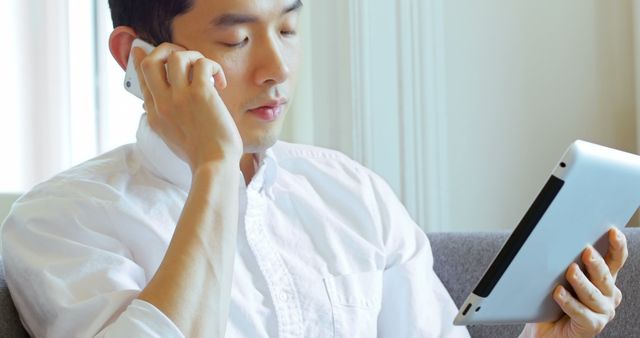 Man Engaged in Business Call While Using Touchscreen Tablet - Download Free Stock Images Pikwizard.com