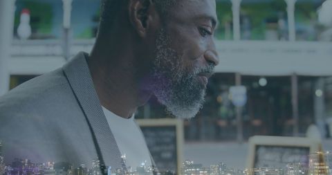 Professional man analyzing digital information at night