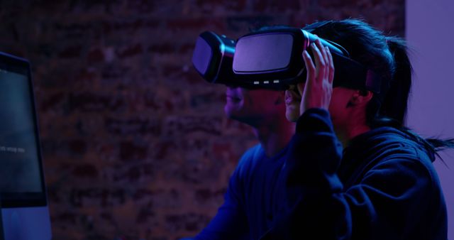 People Experiencing Virtual Reality with VR Headsets in Dimly Lit Room - Download Free Stock Images Pikwizard.com