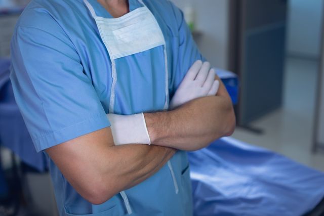 Male surgeon standing with arms crossed in operating room at hospital - Download Free Stock Photos Pikwizard.com