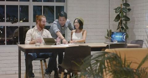 Team Collaboration in Modern Office Setting on Project Development