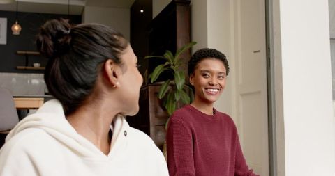 Diverse friends engaging in relaxed home kitchen conversation