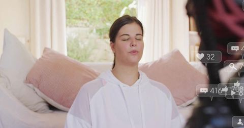 Content creator meditating while filming livestream in home studio