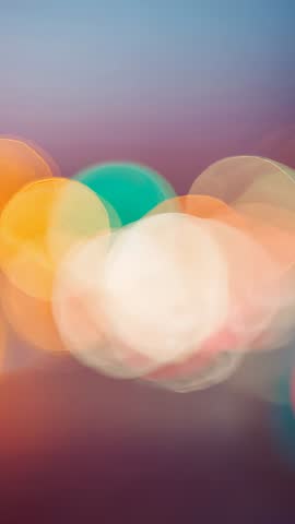 Vertical video showcasing colorful bokeh orbs drifting across pastel gradient background