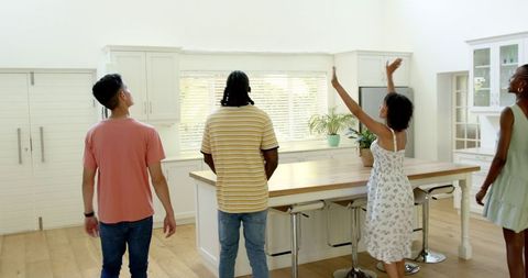 Group of friends enjoying casual gathering in modern kitchen