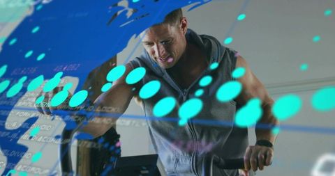 High-tech indoor cycling workout with cyan data overlay, man pedaling on exercise bike