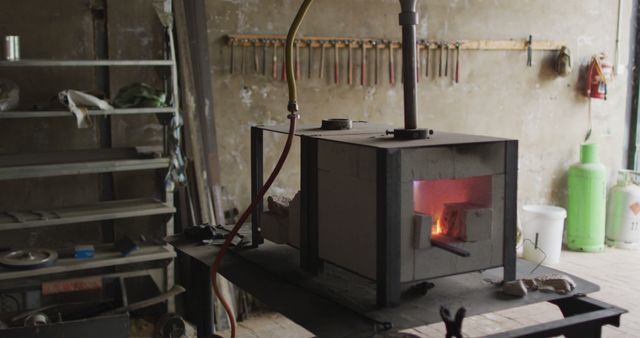 Vacant Workshop with Metal Heating Furnace and Tools on Wall - Download Free Stock Images Pikwizard.com