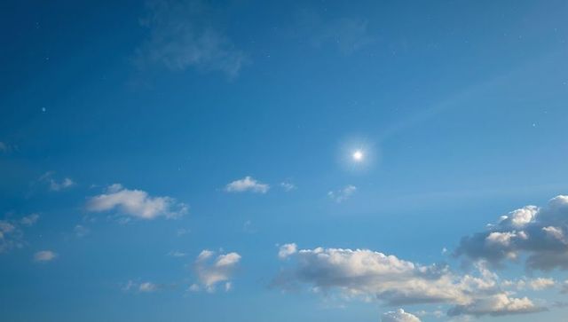 Sunny Blue Sky with Scattered Clouds Creating Serene Atmosphere
