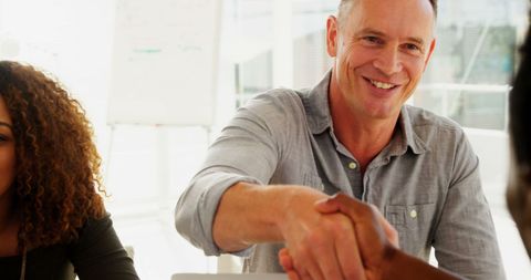 Smiling Businessman Shaking Hands Sealing Partnership - Download Free Stock Images Pikwizard.com