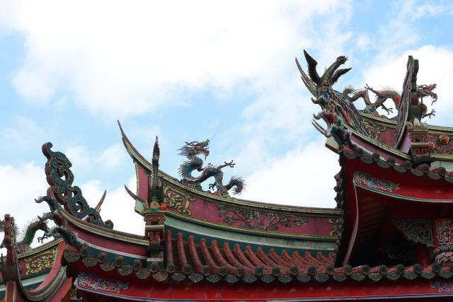 Features detailed roof designs of a traditional Chinese building under a clear blue sky. Ideal for content relating to historical architecture, cultural heritage, Asian art, and travel destinations in China.