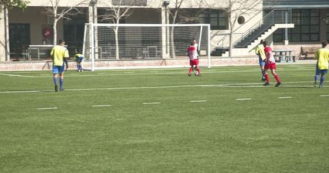 Youth Soccer Match, Players Competing with Intense Focus on Grass Field