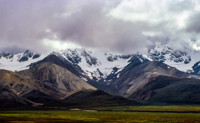 Majestic Snow-Capped Mountain Peaks Under Cloudy Sky - Download Free Stock Photos Pikwizard.com
