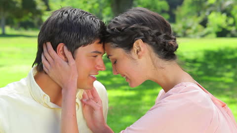 Happy Couple Embracing in Sunny Public Garden