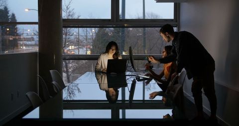 Evening Meeting in Modern Office with Team Collaboration