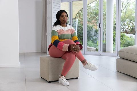 Relaxed woman enjoying comfortable living room ambiance