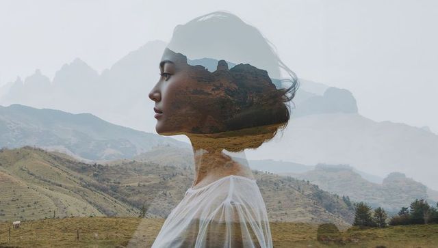 Double Exposure of Woman and Tranquil Mountain Landscape