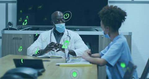 Doctor consulting with nurse while reviewing digital patient data with augmented reality