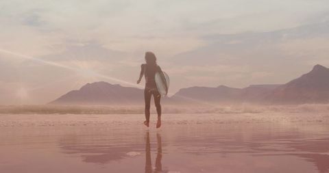 Surfer Woman Enjoying Sunrise Beach Walk with Surfboard