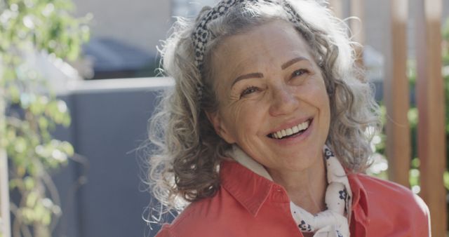 Smiling Senior Woman with Curly Gray Hair Enjoying Sunny Day Outdoors - Download Free Stock Images Pikwizard.com