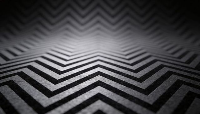 Monochrome chevron textile pattern with zigzag fiber texture and low-angle depth abstract