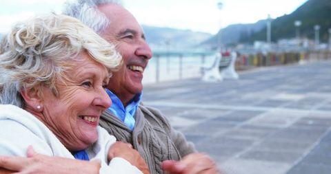 Senior Couple Laughing at Seaside Promenade - Download Free Stock Images Pikwizard.com