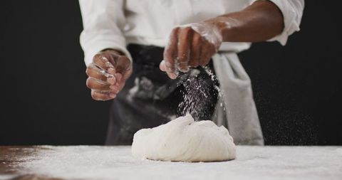 Chef Preparing Dough by Sprinkling Flour for Baking