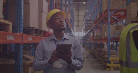 Warehouse Supervisor Inspecting Inventory with Digital Tablet
