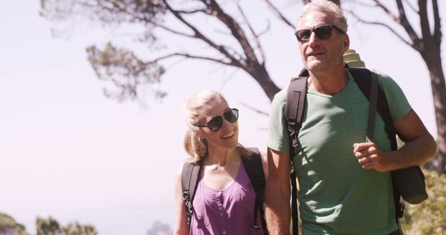 Slow motion of hiker couple walking through forest