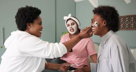 Friends Enjoying Home Spa Day with Facial Masks and Laughs