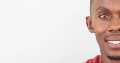 Smiling man posing portrait headshot on white background wearing red tee with copy space