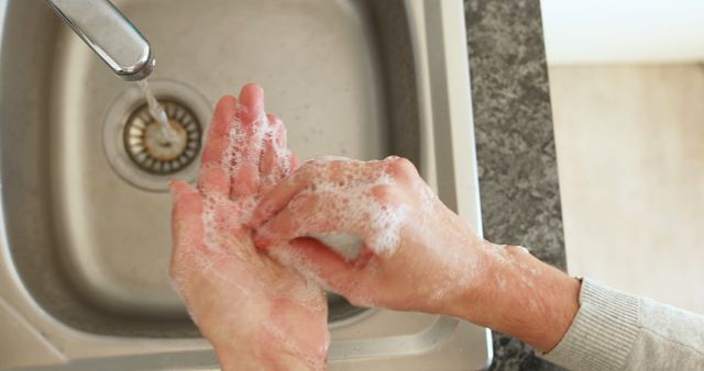 A woman practices hygiene by washing hands during COVID-19 quarantine at home. - Download Free Stock Photos Pikwizard.com