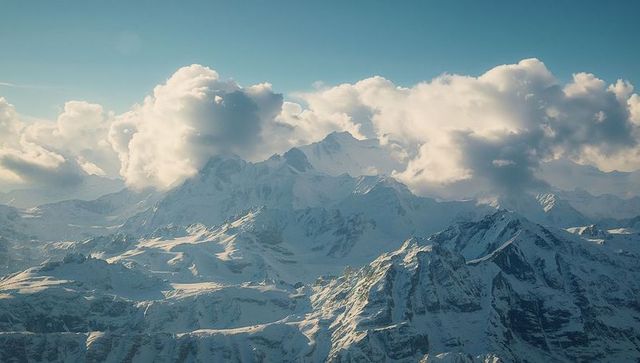 Majestic Snowy Mountain Peak Beneath Billowy Clouds