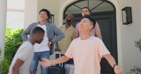 Joyful Reunion of Friends at a Home Entrance