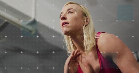 Focused Female Athlete Persevering in Intense Gym Workout