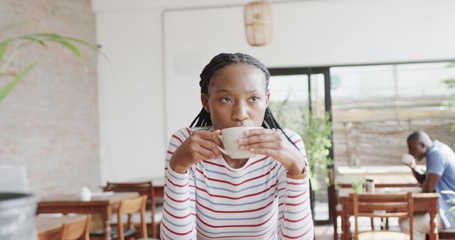 Young Woman Enjoying Coffee in Cozy Cafe - Download Free Stock Images Pikwizard.com