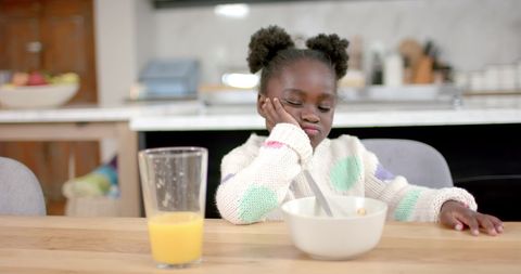 Young Girl Pondering Breakfast in Cozy Kitchen - Download Free Stock Images Pikwizard.com