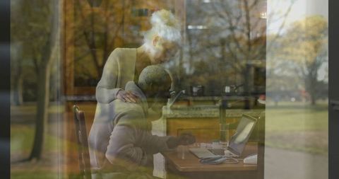 Senior couple collaborating on laptop at home